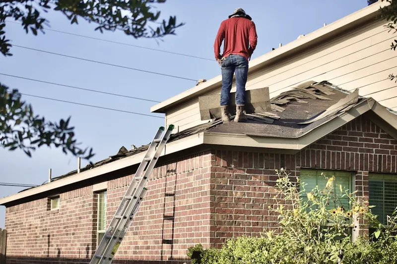 Professional roofer working on a residential roof in Buckley